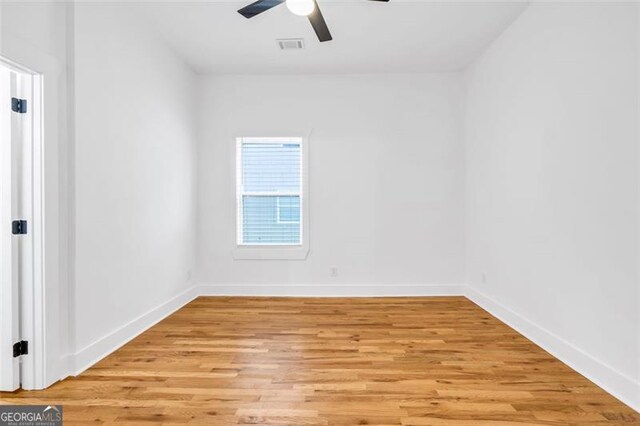 spare room with light wood-type flooring and ceiling fan