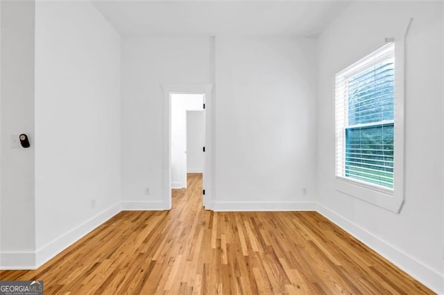 unfurnished room featuring light hardwood / wood-style flooring and a healthy amount of sunlight