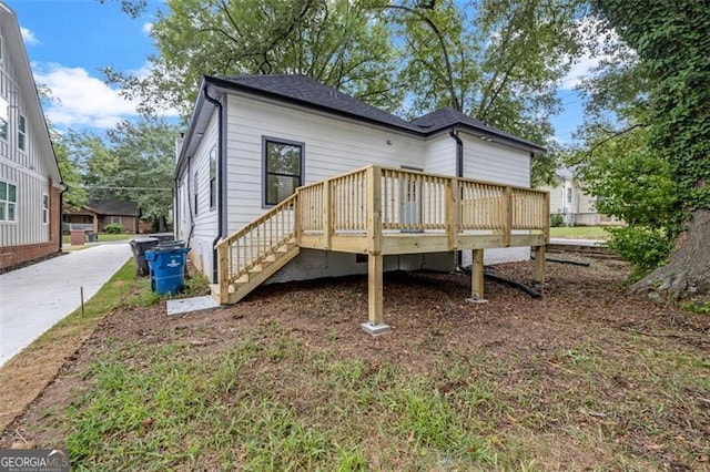 rear view of house with a wooden deck