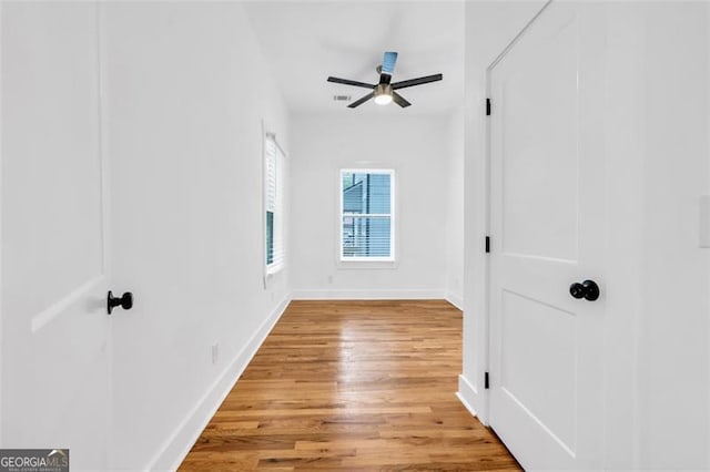 spare room with ceiling fan and wood-type flooring