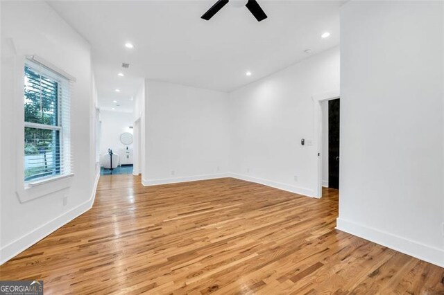 unfurnished room with ceiling fan and light wood-type flooring