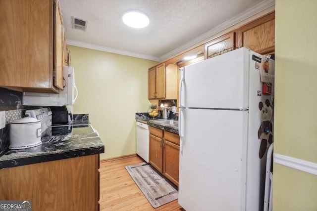 kitchen featuring light wood-type flooring, white appliances, a textured ceiling, and crown molding