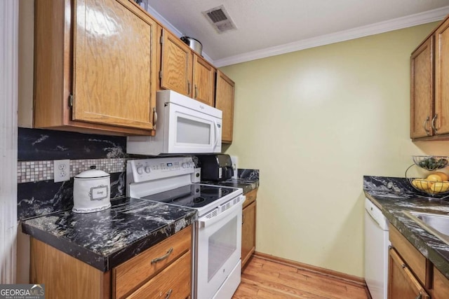 kitchen featuring light hardwood / wood-style flooring, white appliances, ornamental molding, and tasteful backsplash