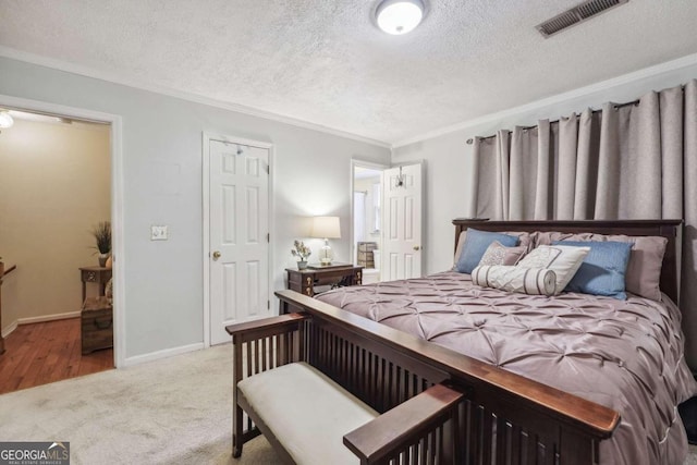 carpeted bedroom featuring a textured ceiling and crown molding