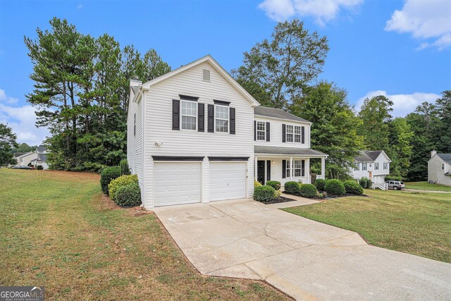 view of front of home featuring a garage, a porch, and a front lawn