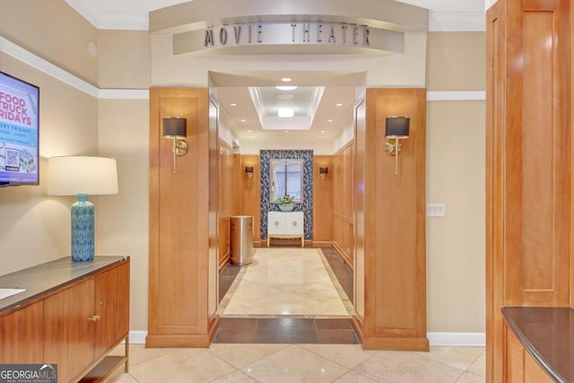 corridor with crown molding, light tile patterned flooring, and a raised ceiling