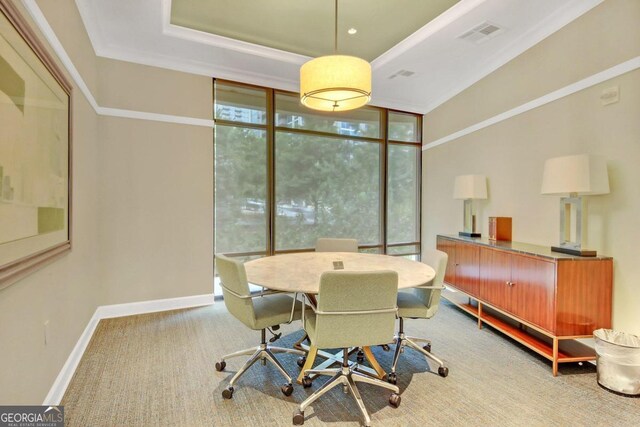 hallway featuring ornamental molding and a tray ceiling