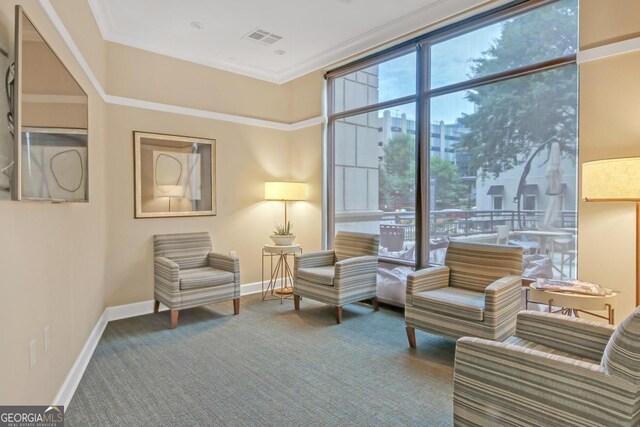 carpeted dining space featuring crown molding