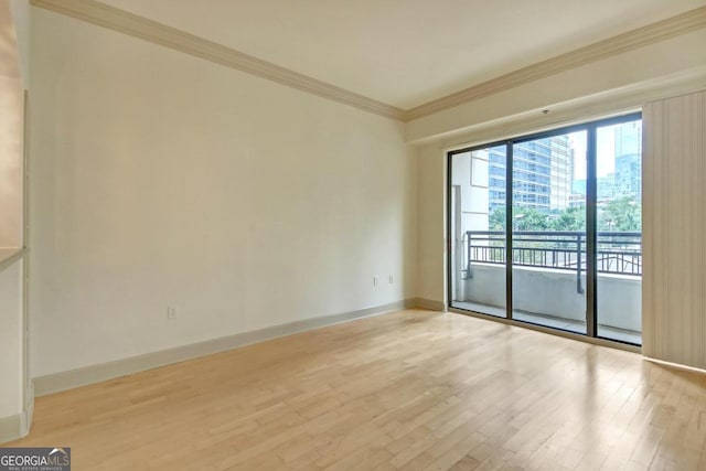 unfurnished room featuring crown molding and light hardwood / wood-style floors