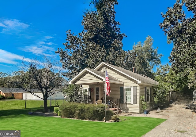 bungalow-style home featuring a porch and a front yard