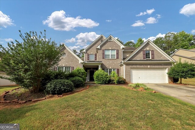 view of front of property with a garage and a front lawn