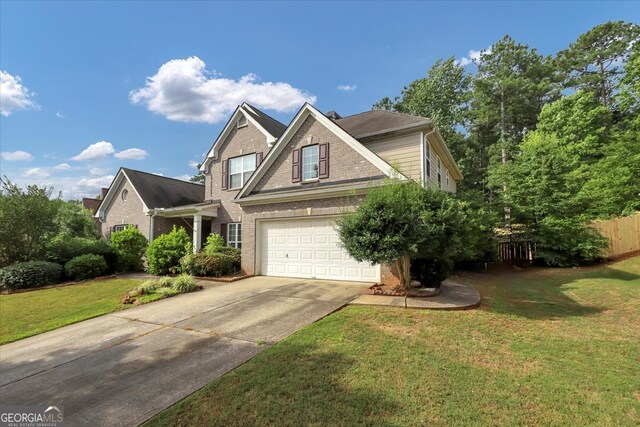 craftsman-style house with a garage and a front lawn