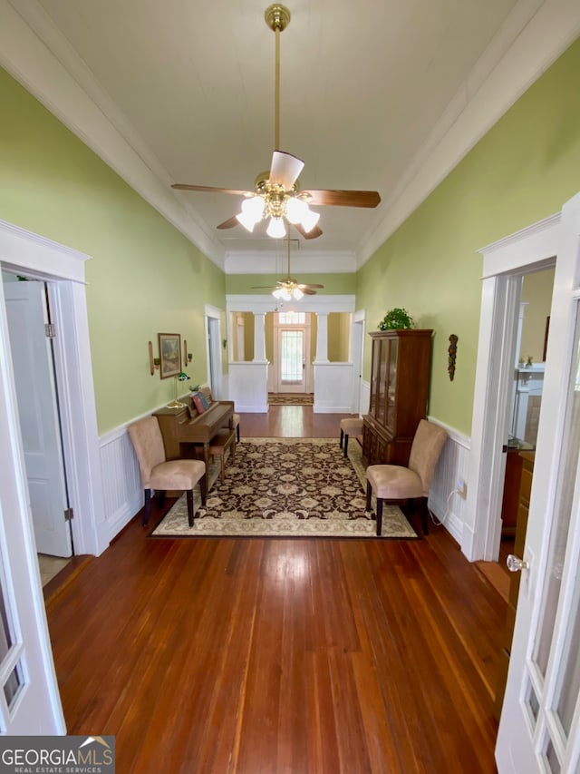 living room featuring ceiling fan, crown molding, and dark hardwood / wood-style flooring