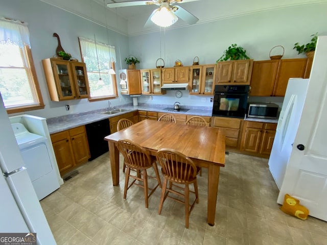 kitchen featuring black appliances, washer / clothes dryer, sink, and ceiling fan