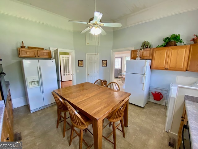 dining space with ornamental molding and ceiling fan