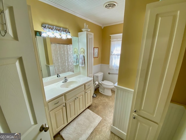 bathroom featuring crown molding, vanity, and toilet