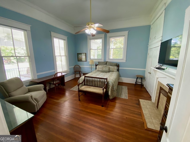 bedroom with multiple windows, ornamental molding, ceiling fan, and dark wood-type flooring