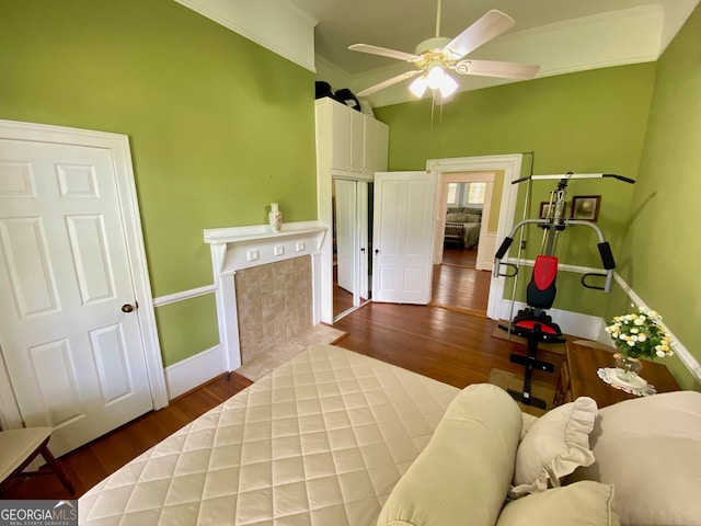 bedroom featuring ceiling fan, crown molding, and dark hardwood / wood-style flooring