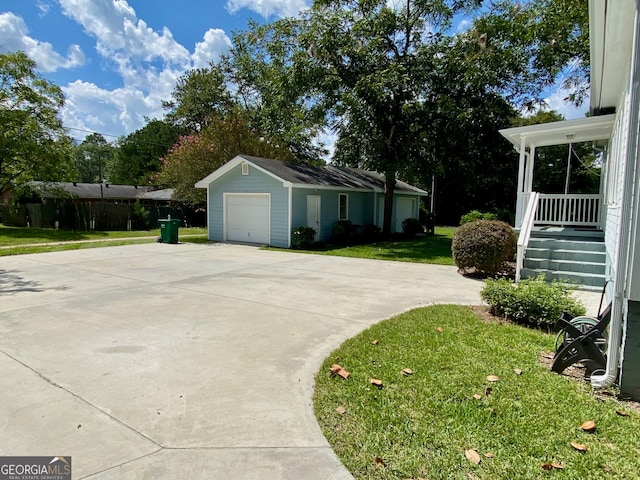 view of side of property featuring a lawn, an outbuilding, and a garage