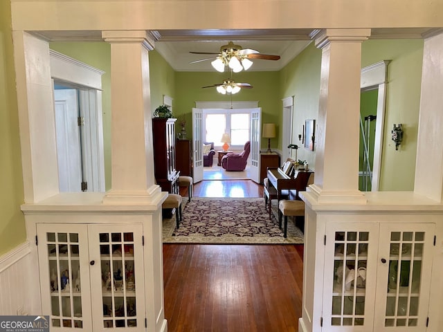 entryway featuring crown molding, decorative columns, dark hardwood / wood-style flooring, and ceiling fan