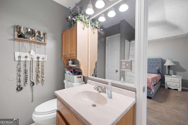 bathroom with vanity, a textured ceiling, and toilet