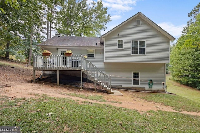 back of house with a wooden deck and a yard