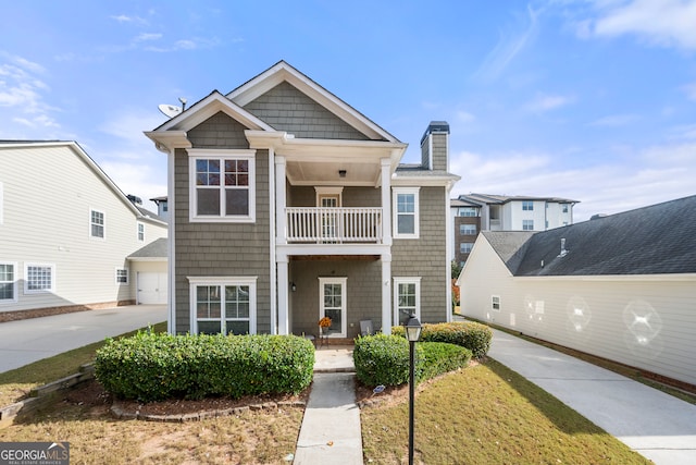 view of front of home featuring a garage and a balcony