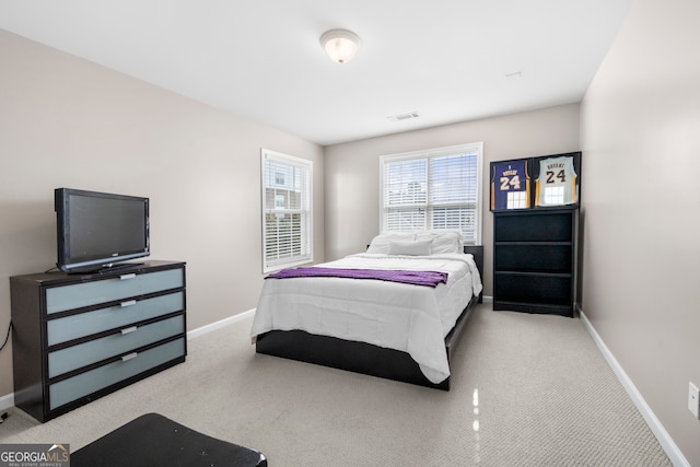 bedroom featuring light carpet