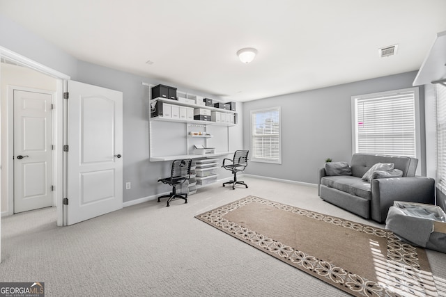 office area with built in desk and carpet flooring