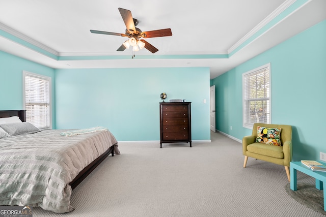 bedroom with light carpet, multiple windows, a raised ceiling, and ceiling fan