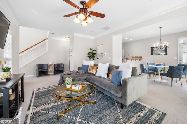 carpeted living room featuring crown molding and ceiling fan with notable chandelier