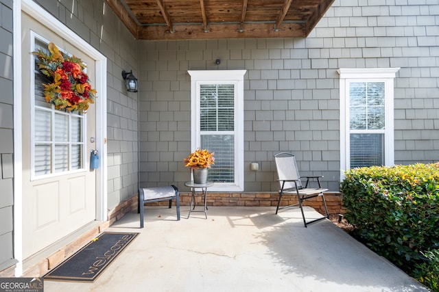 view of exterior entry featuring a patio