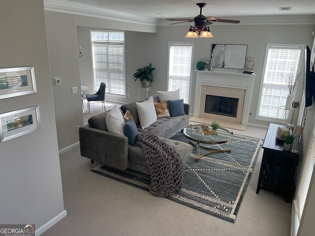 living room featuring light carpet, ornamental molding, plenty of natural light, and ceiling fan