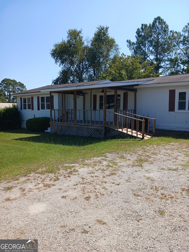 view of front of property with a porch and a front lawn