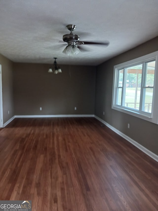 empty room featuring dark hardwood / wood-style floors and ceiling fan