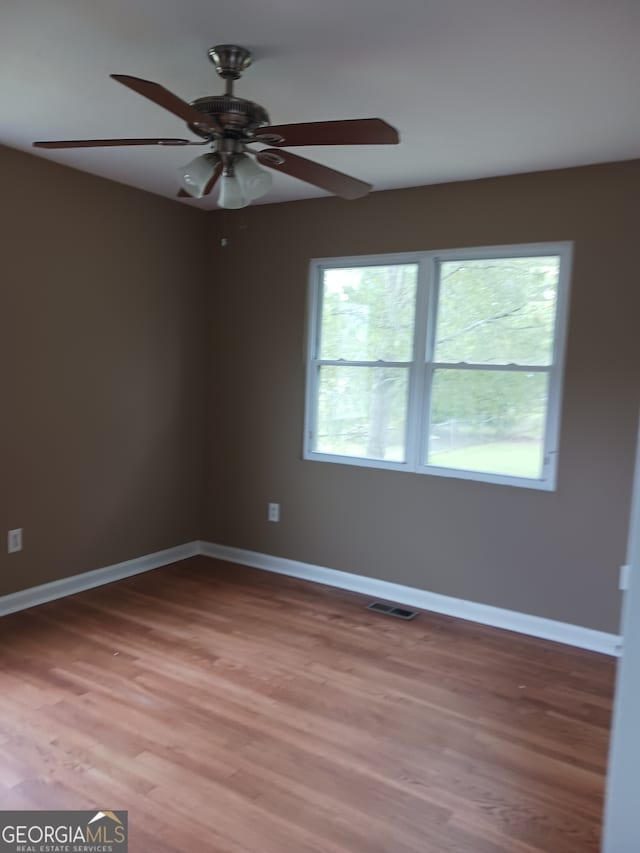 unfurnished room featuring ceiling fan and hardwood / wood-style flooring