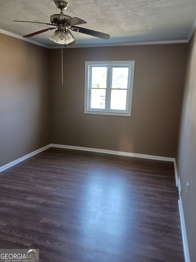 empty room featuring ornamental molding, ceiling fan, and dark hardwood / wood-style flooring