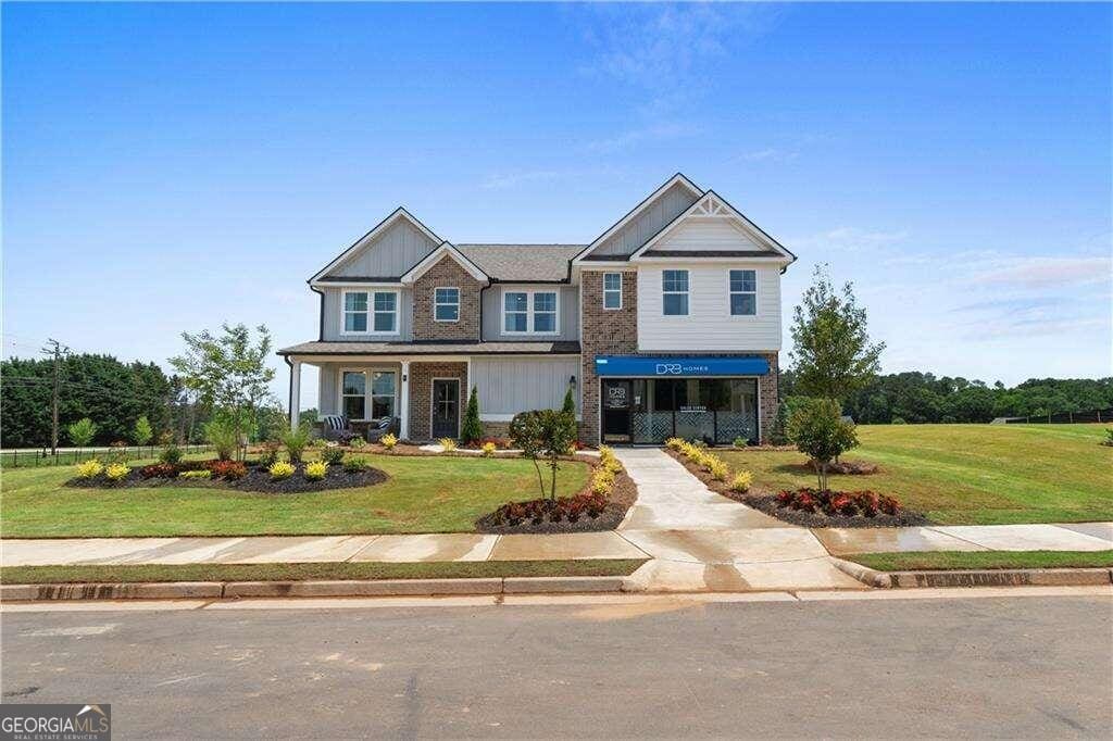 craftsman inspired home with covered porch and a front yard