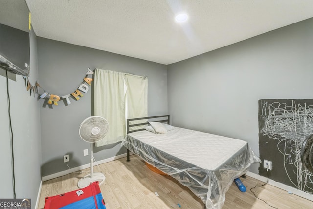 bedroom with hardwood / wood-style floors