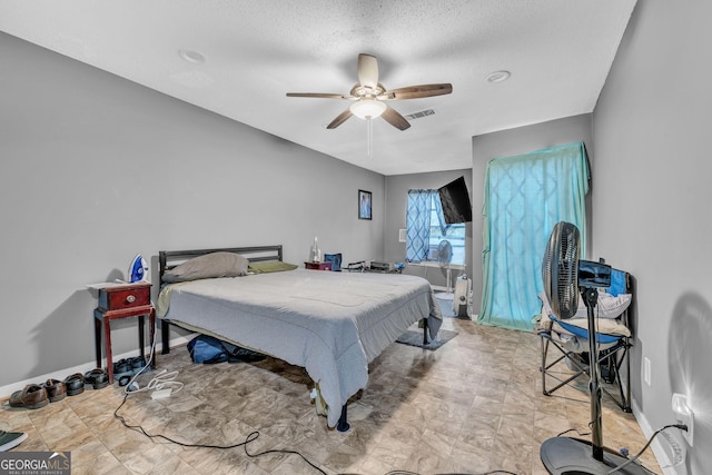 bedroom featuring a textured ceiling and ceiling fan