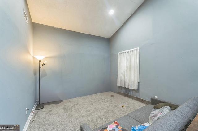 living area featuring carpet flooring and high vaulted ceiling