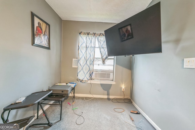 misc room featuring carpet floors, cooling unit, and a textured ceiling