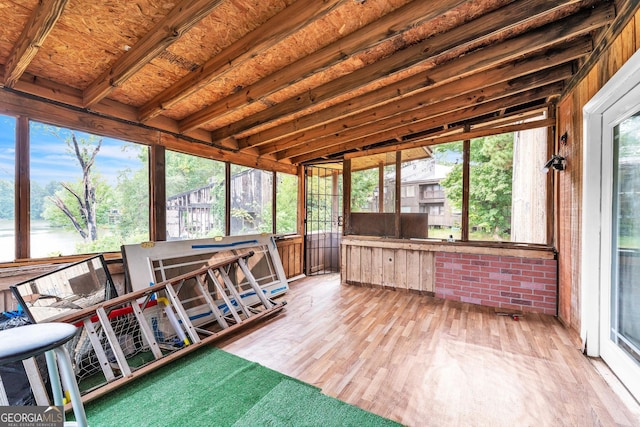 sunroom / solarium featuring a wealth of natural light and lofted ceiling