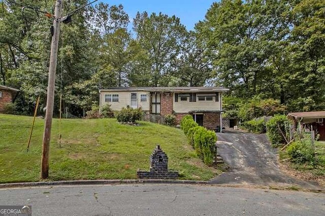 raised ranch with a front yard