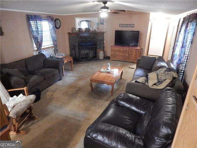 carpeted living room with ceiling fan, a stone fireplace, a textured ceiling, and crown molding