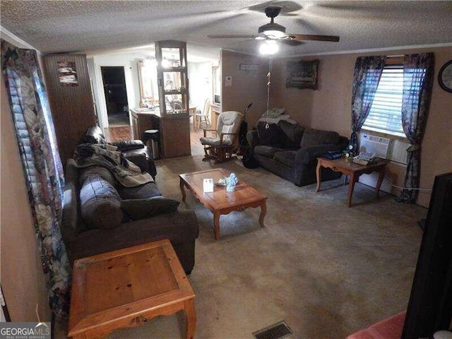 living room with carpet, ceiling fan, and a textured ceiling