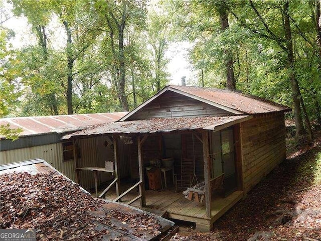 rear view of house with a wooden deck