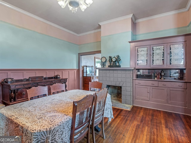 dining space with crown molding and dark hardwood / wood-style flooring