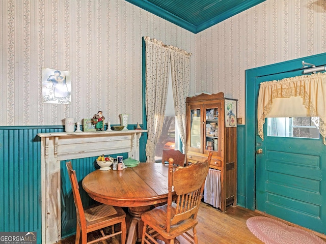 dining space with crown molding and hardwood / wood-style floors