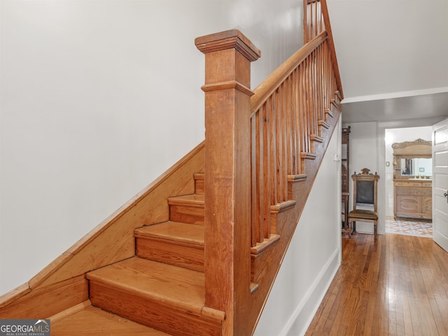 stairway with hardwood / wood-style floors